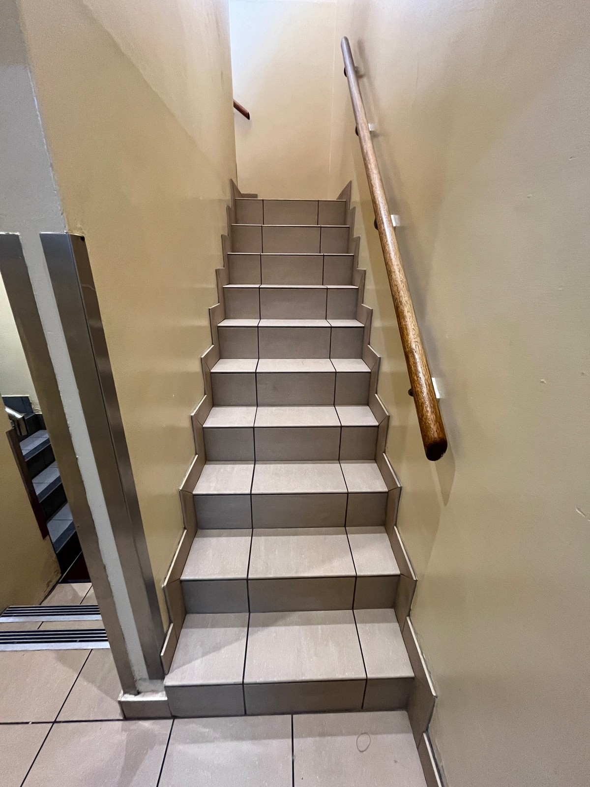Staircase up to landing. Handrail on right.