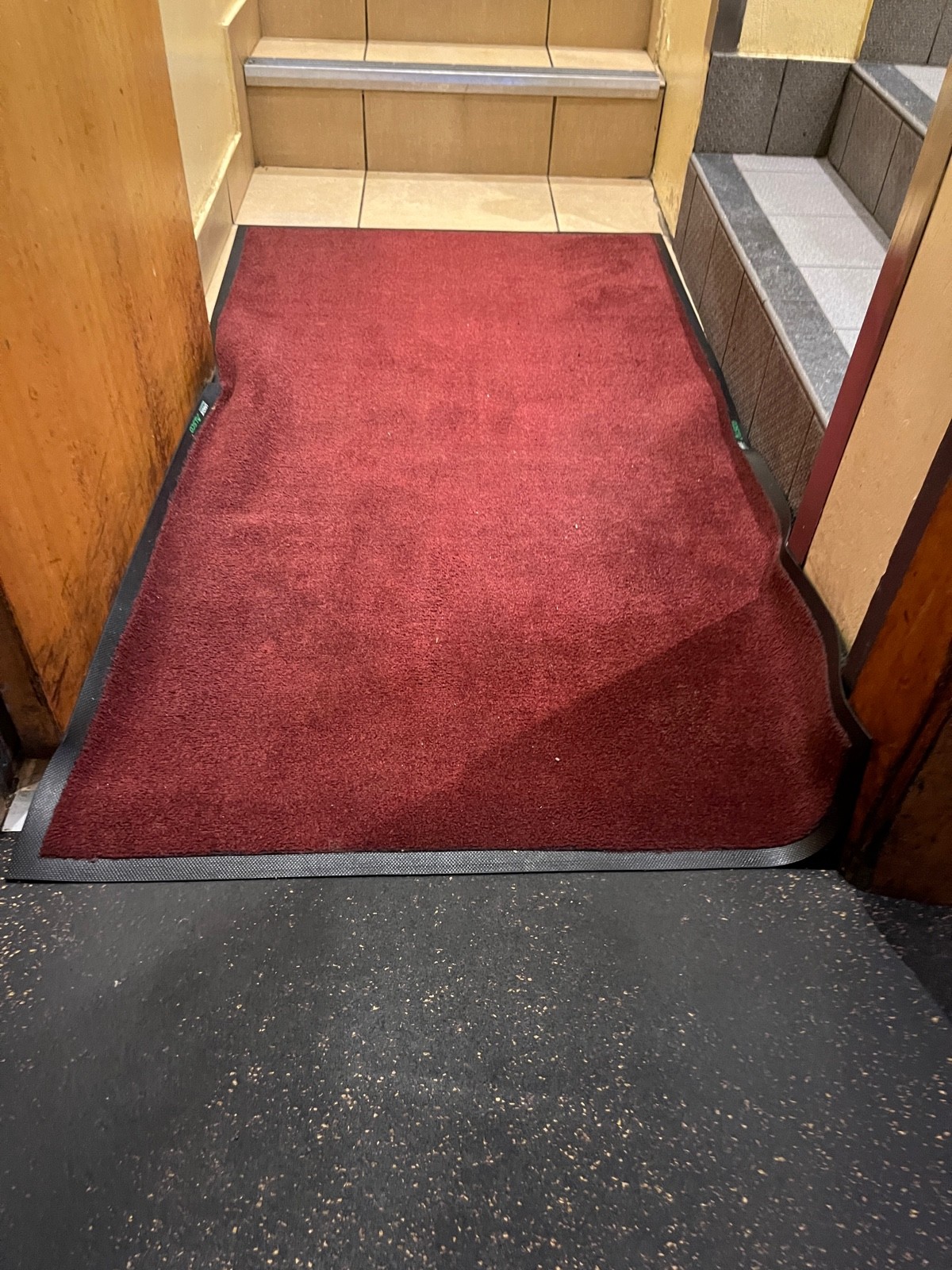 Doormat at foot of door.