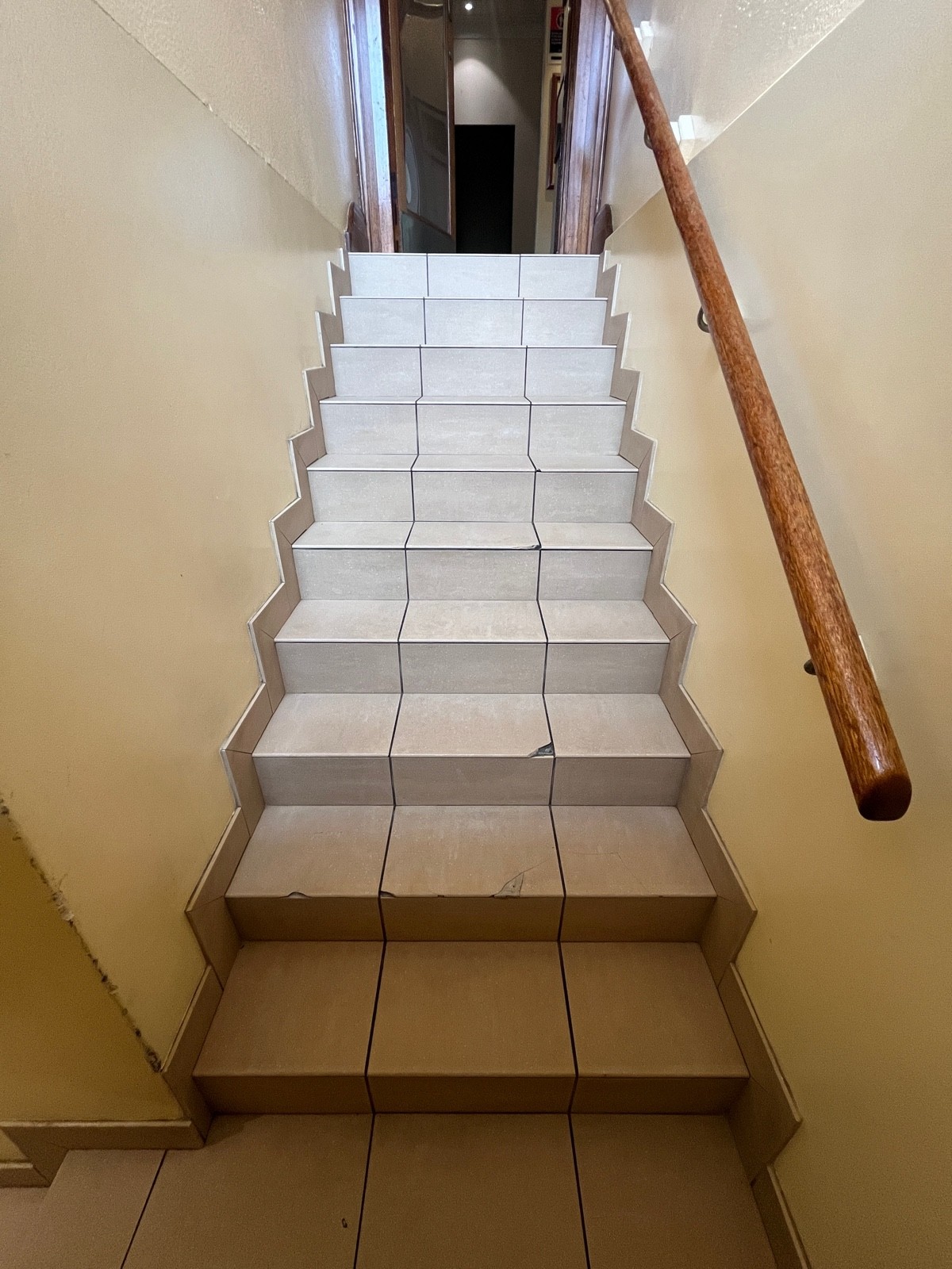 From landing facing left. Handrail on right. Top of stairs ahead.