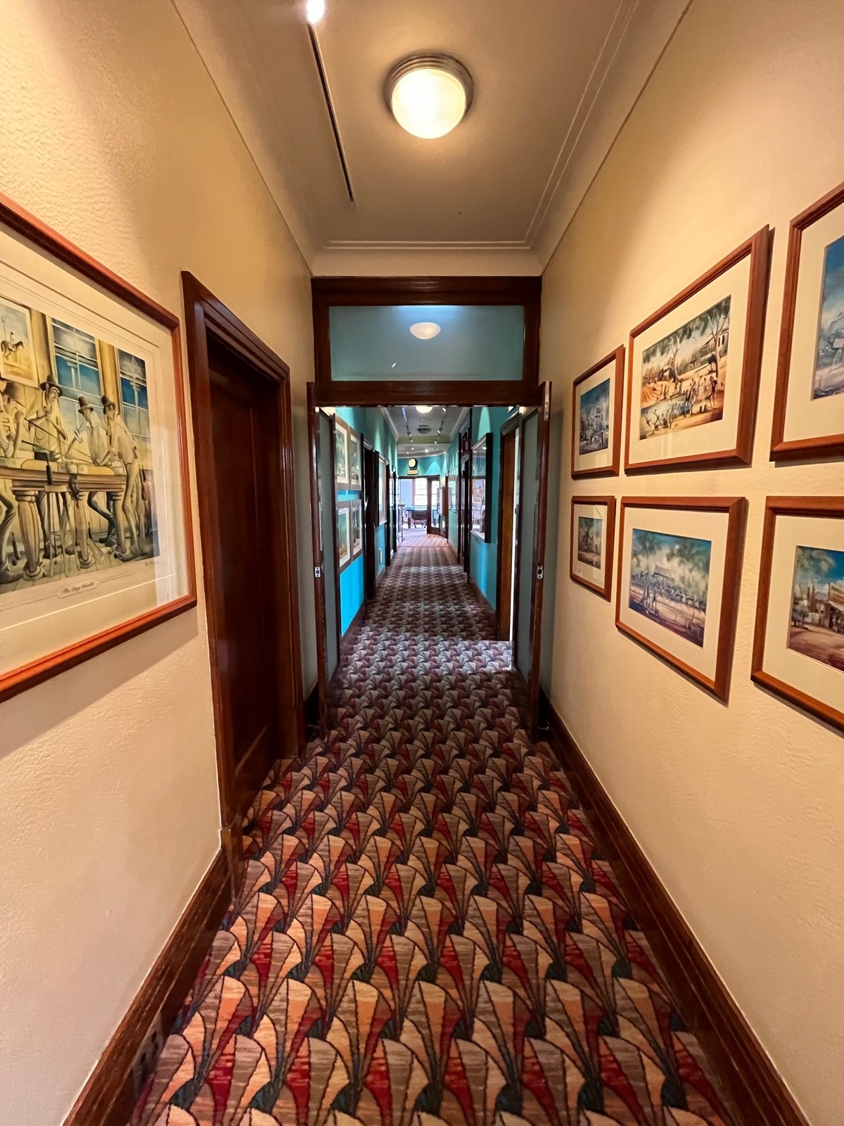 From after door to first room facing right. Glass double doors with brown wooden frame directly ahead. No handles to pull. Doors typically kept open.