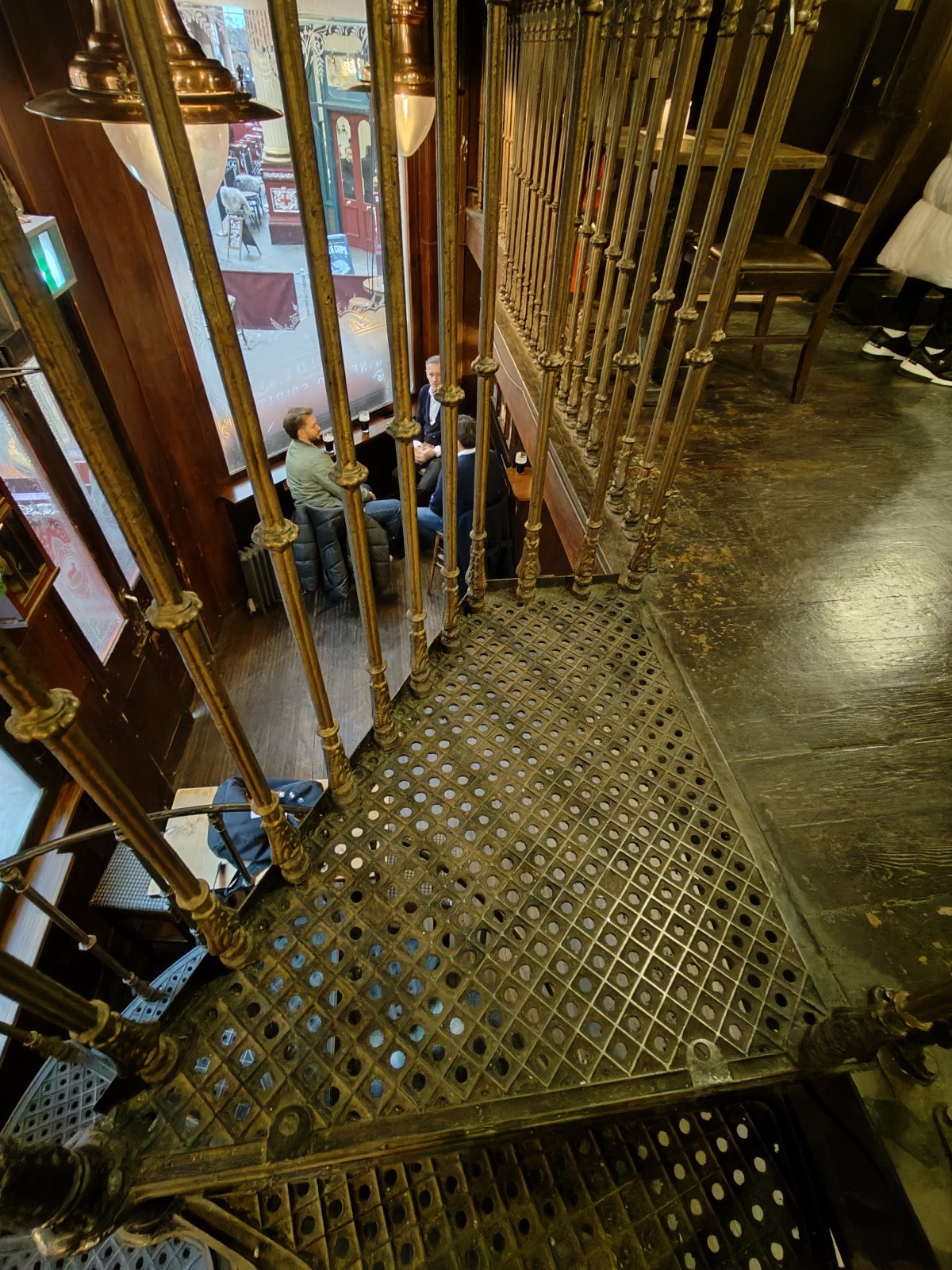 From second curve of stairs facing left. Path ahead going right to seating. Handrail on left.