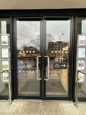 Glass doors with black frame. Doors open outwards.