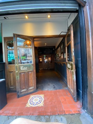 Wooden doors with glass panels ahead. Pull from centre to open.