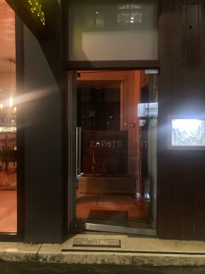 Glass door ahead. Push door to open via handle on left.