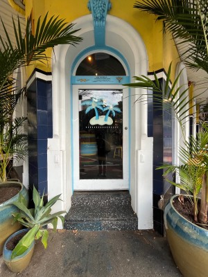White wood-framed glass door. Push from right to open.