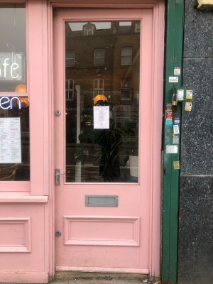 Pink and glass panelled door. Push handle from left to open.