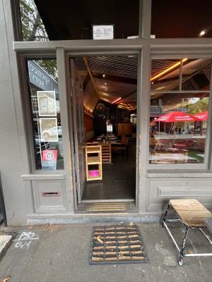 Door with grey wooden frame. Push from right.