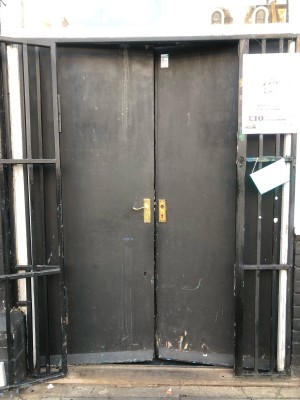 Black wooden doors, push from right to open.
