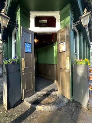 Preceding green wooden doors ahead. Pull gold handles in centre to open.