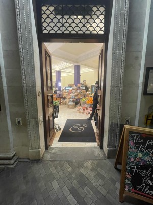 Brown wooden doors ahead. Push from centre to open.