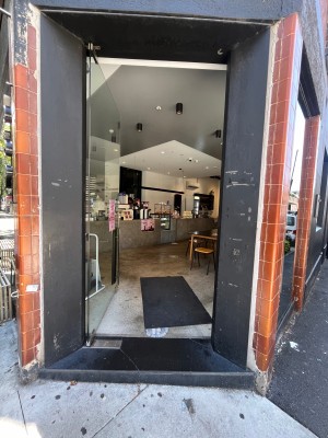 Glass door. Push from silver handle on right.