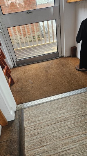 A rough hessian mat in the doorway. Level entrance