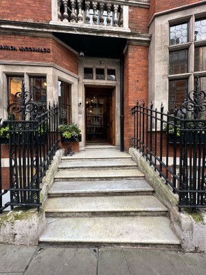 3 steps up to entrance ahead. Black metal railings on either side.
