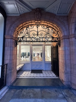 Opening and black gate ahead. Gate propped open to right.
