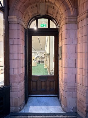 Wood and glass panelled door. Push handle from left to open.
