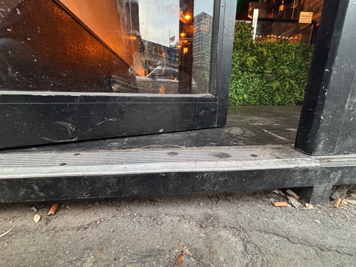Small step at foot of door.