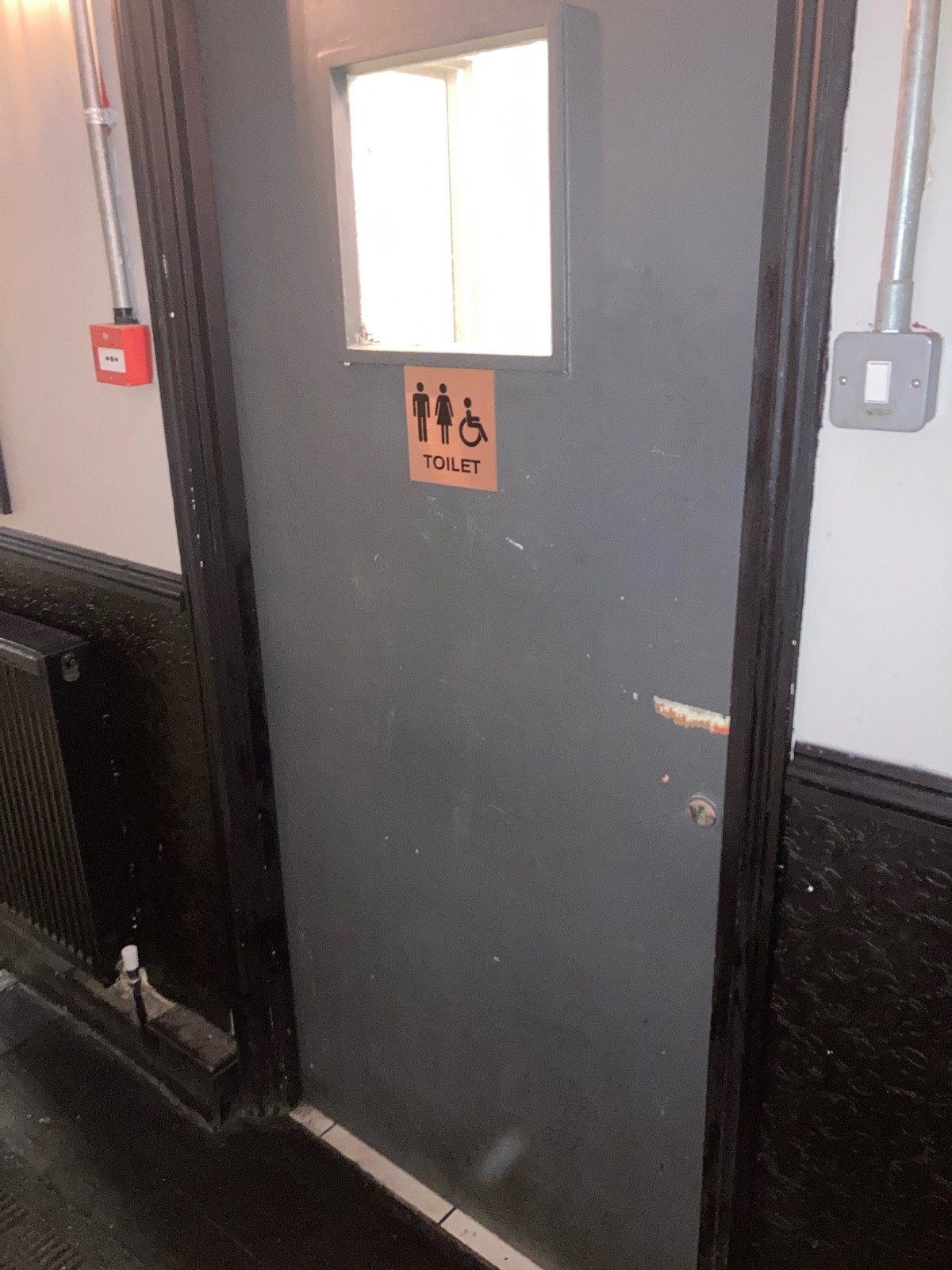 From midway of path facing right. Grey door ahead push door to open from right.