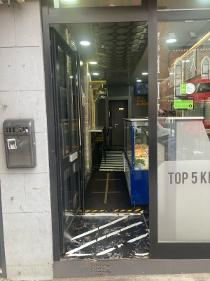 Glass door with black frame. Push door to open from right.