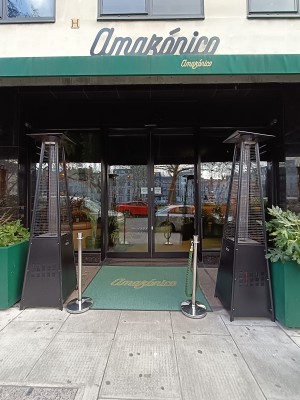 From street, facing venues. Gas heaters on both sides. Path ahead to doorway at back.