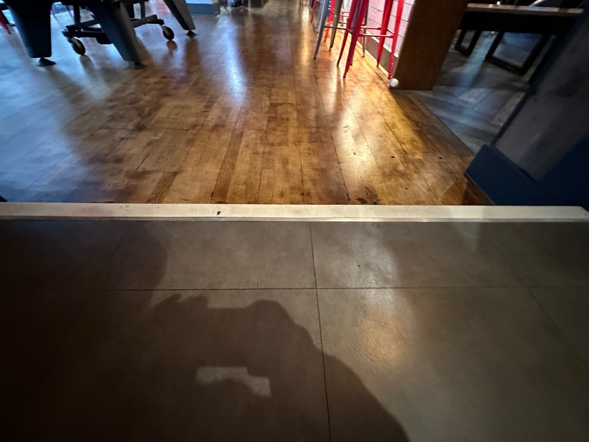 One step down at foot of archway.