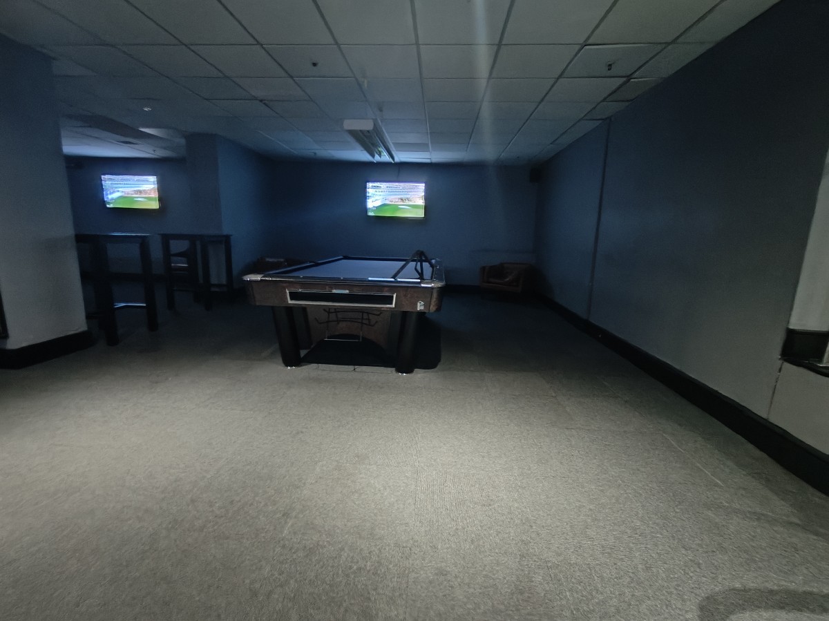 From bottom of steps facing right. Pool table at back. Stools to its left.