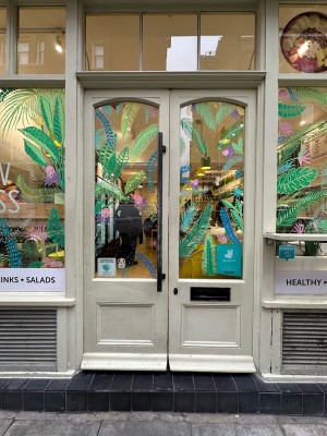Cream and glass panelled doors. Push metal handle from right side of left-hand door to open.