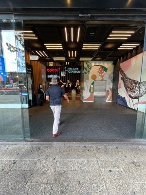 Glass double doors slide open from middle automatically.