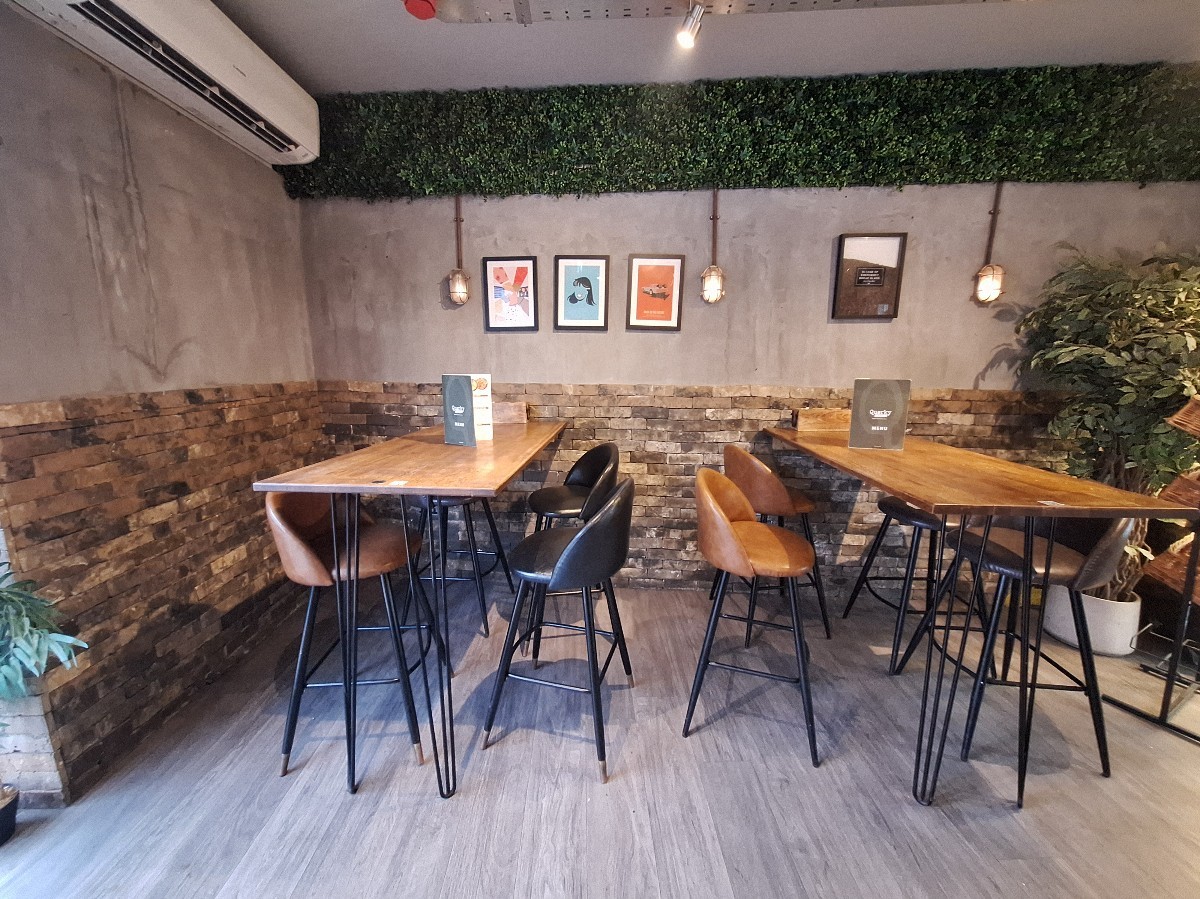 From entrance facing left. High tables and stools along back wall.