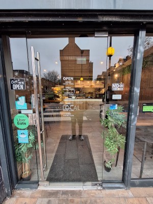 Glass door ahead. Push metal handle on left to open.