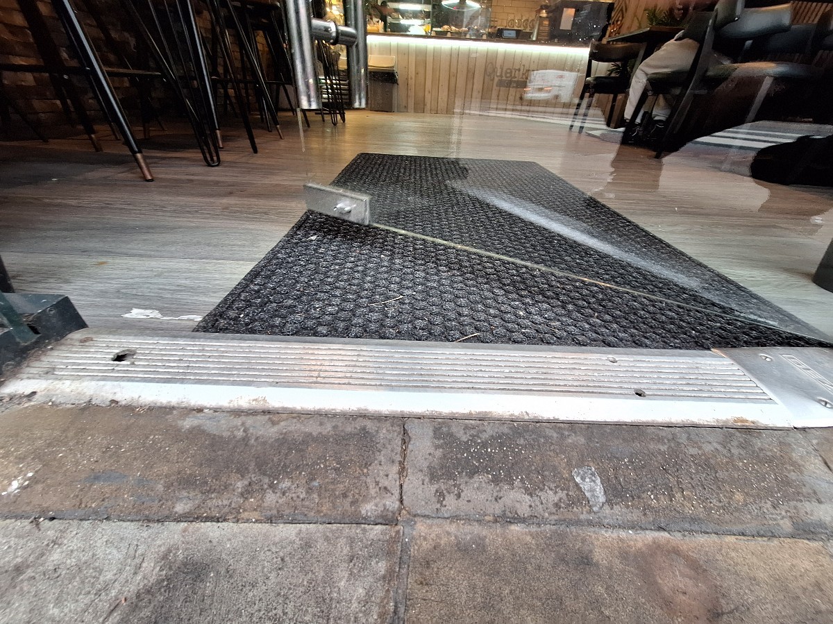Bump at foot of door. Doormat after.