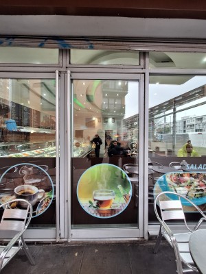 Glass doors ahead. Push metal handles in centre to open.