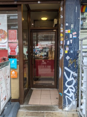 Open doorway ahead with brown frame.