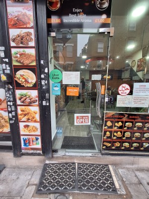 Glass door ahead. Push metal handle on right to open. Two steps up to door.