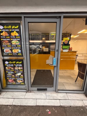 Glass door with metal frame ahead. Push metal handle at right to open.