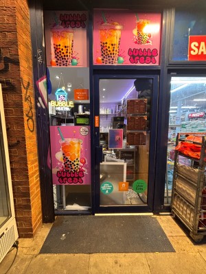 Glass door with black doorframe ahead. Pull metal handle at left to open. Order desk immediately behind door.