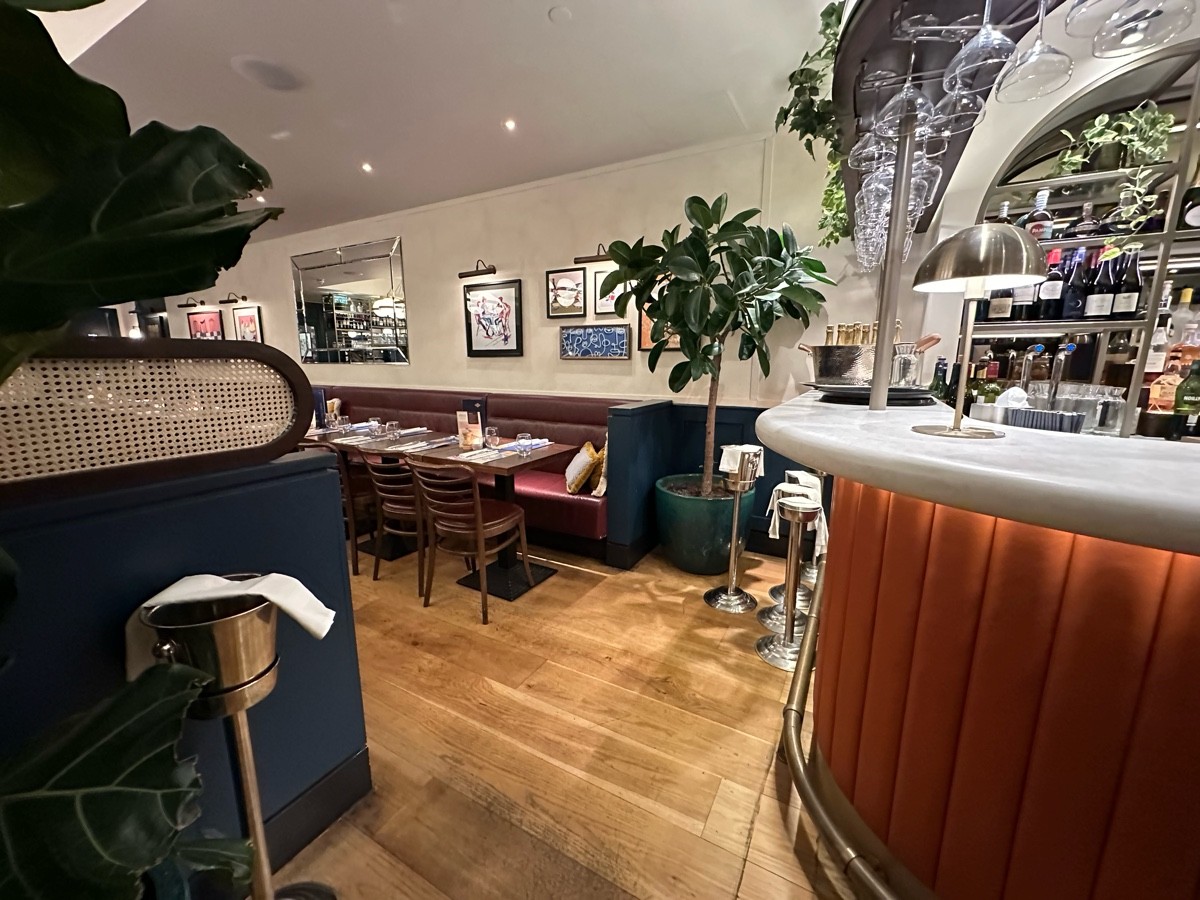 From corner of bar facing right. Divider to left. Opening ahead. Bar to right.