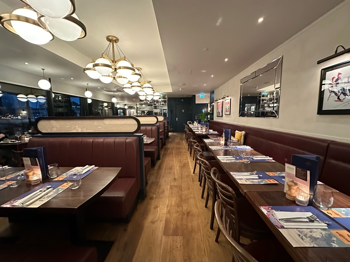From end of bar facing straight. Booths along left. Half booths along right.