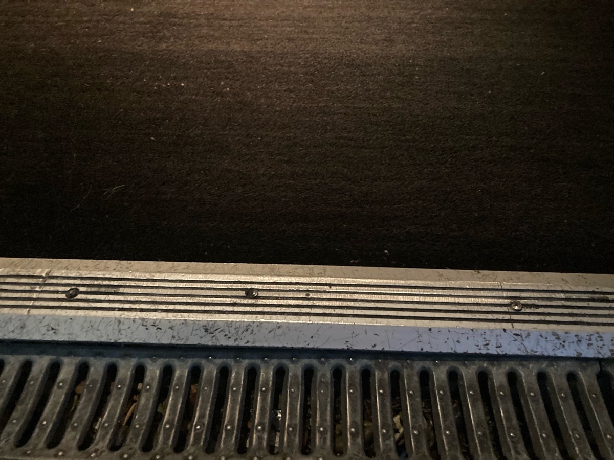 Small bump at foot of doors followed by doormat.