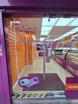 Glass door ahead. Push metal handle on right to open.