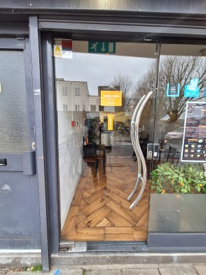 Glass door ahead. Push on right metal handle to open.