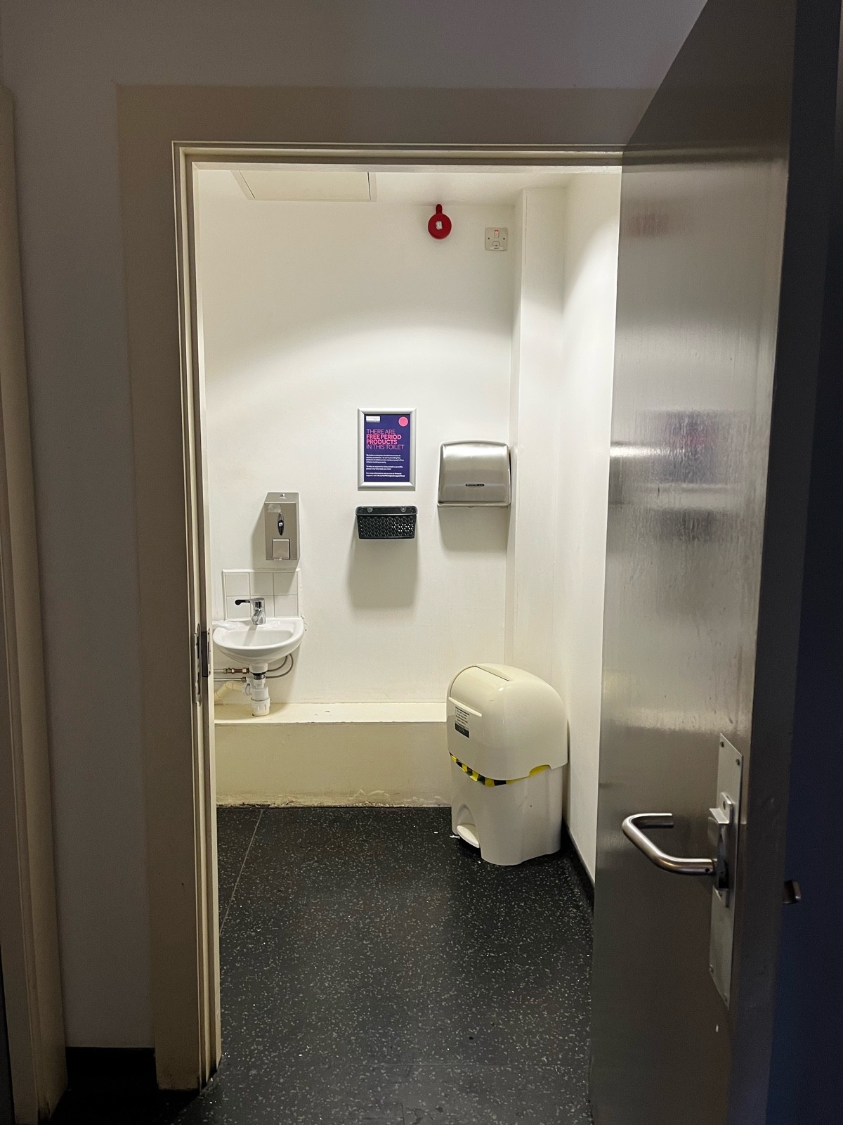 Wheelchair accessible toilet located at the end of corridor.