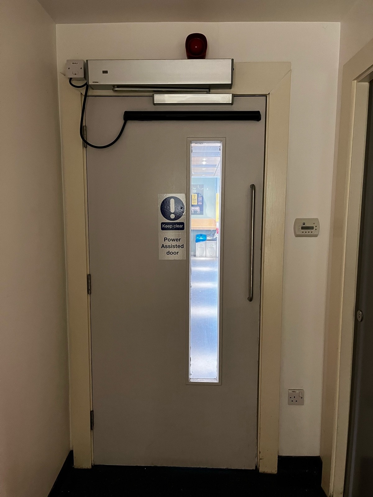 Power-assisted corridor door from inside of corridor.