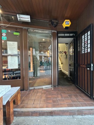 Step up to glass door at back. Pull wooden handle on left to open.