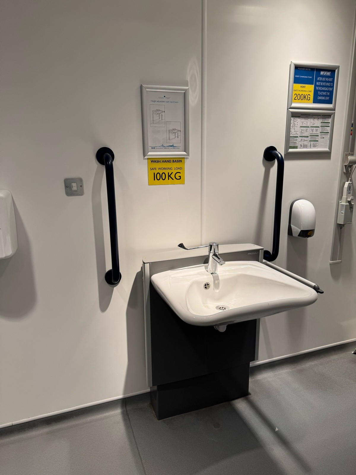 Hight adjustable sink soap on right and hand dryer on the left