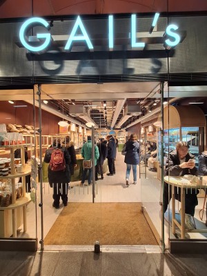 Glass doors ahead. Push metal handles in centre to open.