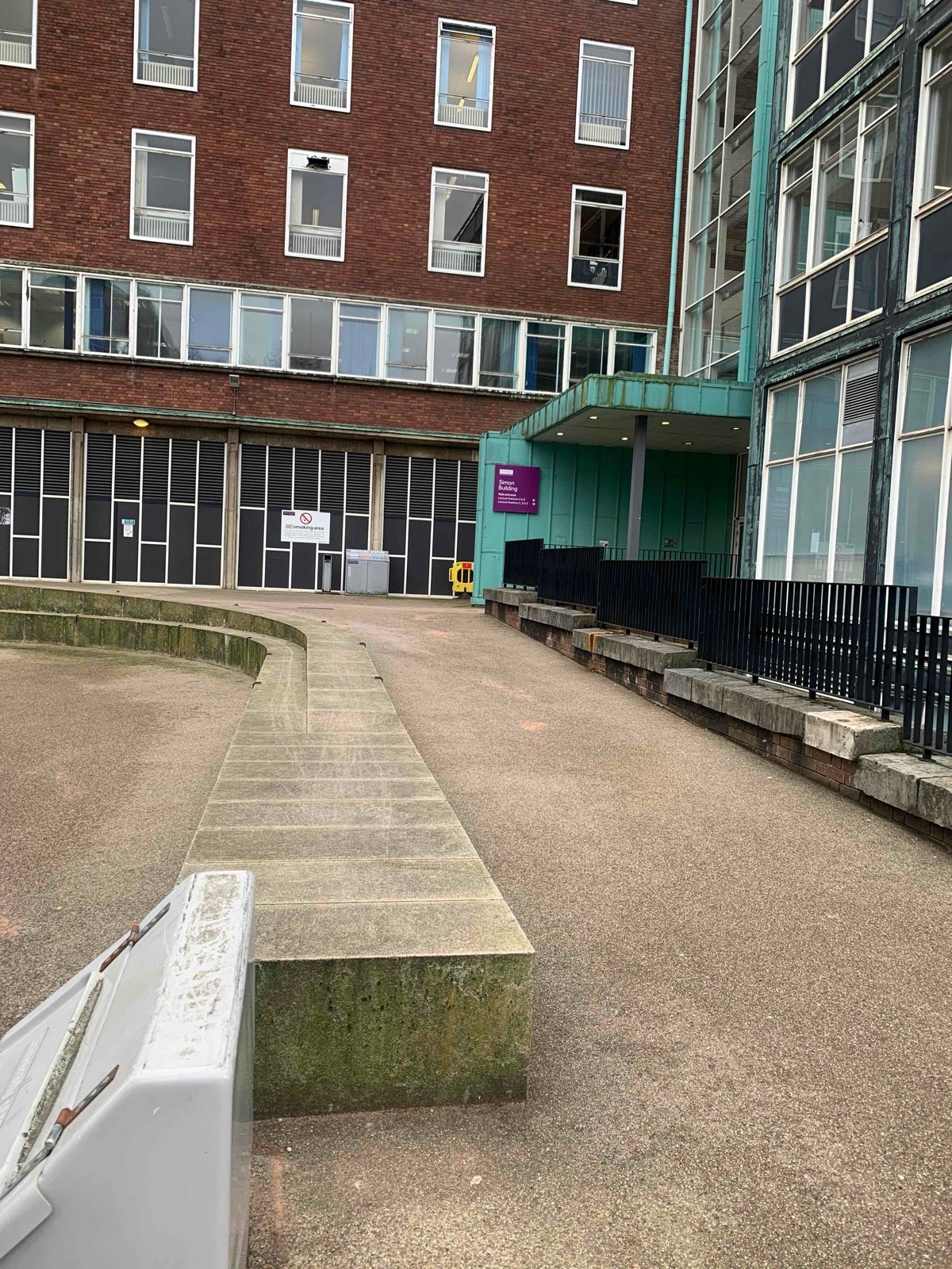 Gentle slope to the side entrance 
On the left of the main entrance