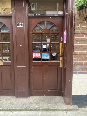 Wooden door with glass panels ahead. Push to open via handle on right.