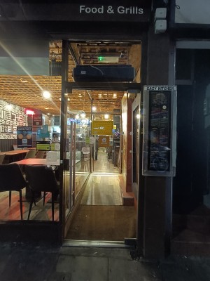 Glass door with silver handle on left. Pull to open.