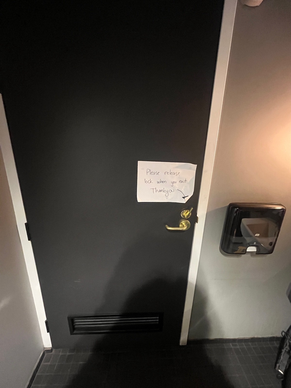 Back of door. Turn lock on right above gold handle. Pull to open.