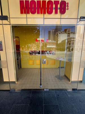 Glass doors with silver handle in middle on left door. Pull to open.